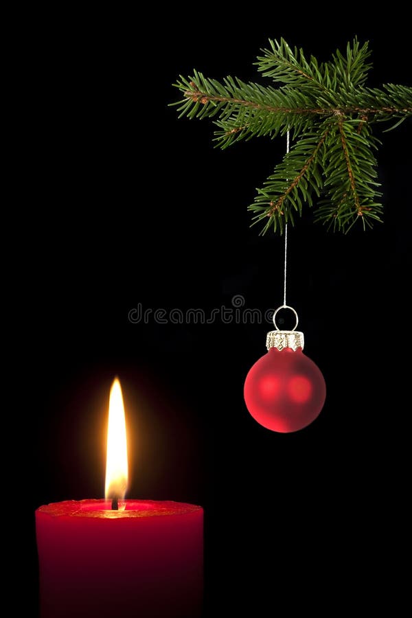 Fir branch with Christmas tree ball and red candle