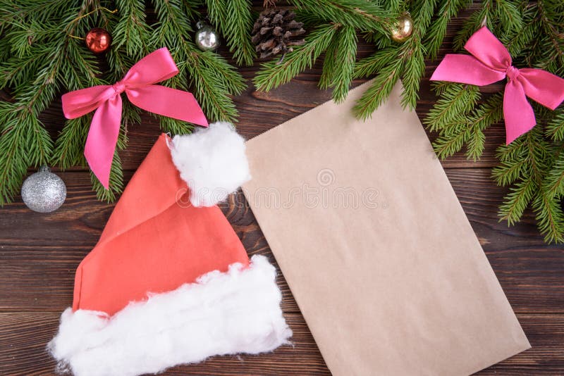 Fir branches, pink ribbon bow, Christmas cap, envelope and christmas balls. New Year background. stock images Fir branches, pink ribbon bow, Christmas cap, envelope and christmas balls. New Year background. stock images
