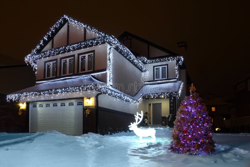 Fir-tree is decorated festoons stand near house