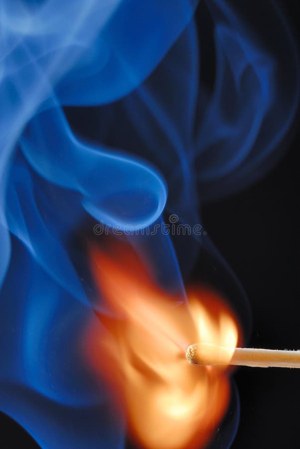 Macro of burning match and smoke on black background. Macro of burning match and smoke on black background