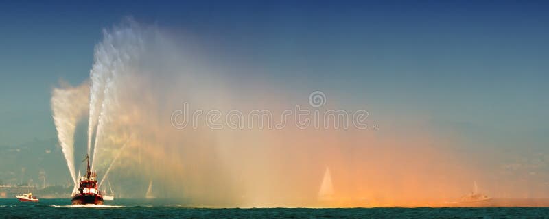 Fire boat spraying bright streams of water in demonstration on F stock image Fire boat spraying bright streams of water in demonstration on F stock image