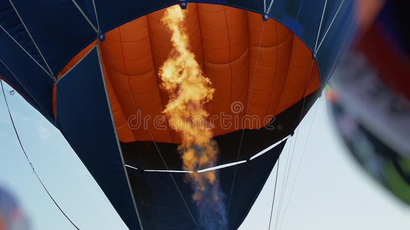 Fire from burner inflates hot air balloon. Flame tongue.