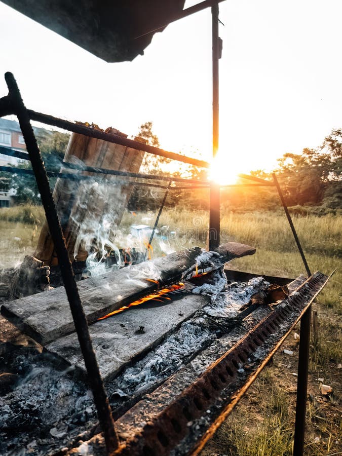 Fire Burning the Wood while Cooking Lemang on the Sunset Stock Image