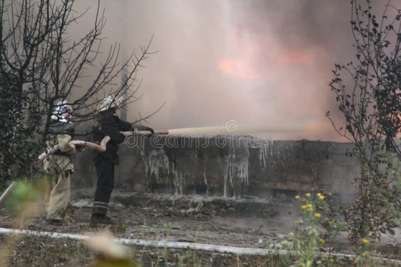 Fire Department in Action during Burning Warehouses with Plastic