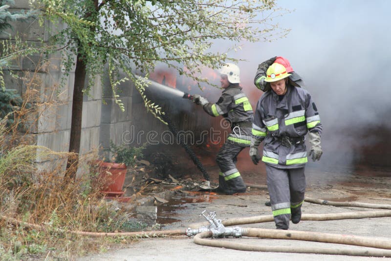 Fire Department in Action during Burning Warehouses with Plastic