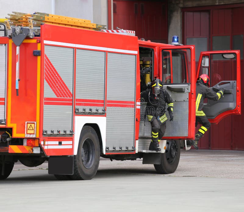 Fire Engine with Many Firefighters and Equipment for Fighting Fi Stock