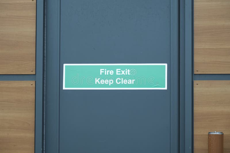 fire-exit-keep-clear-sign-on-construction-building-site-door-stock