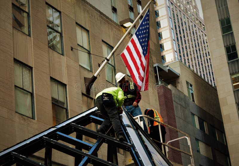 Fire fighters construction in New York City with American flag stock photography Fire fighters construction in New York City with American flag stock photography