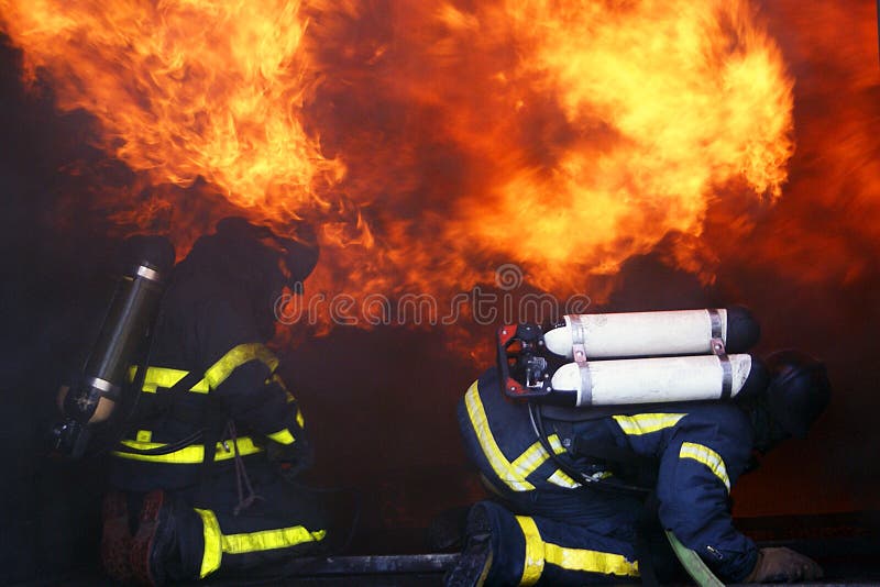 Fire men in action burning building