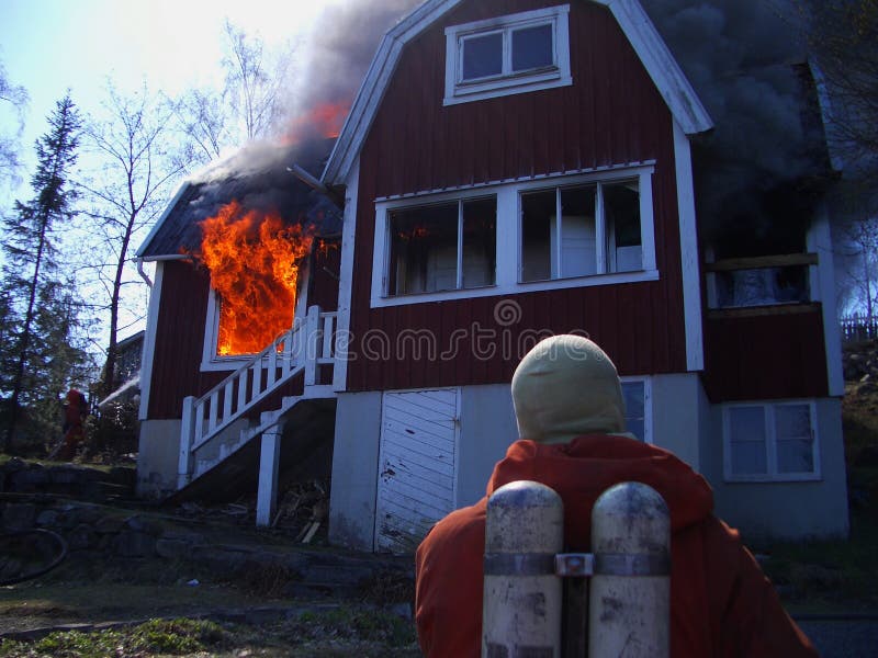 Fire men in action, house burning