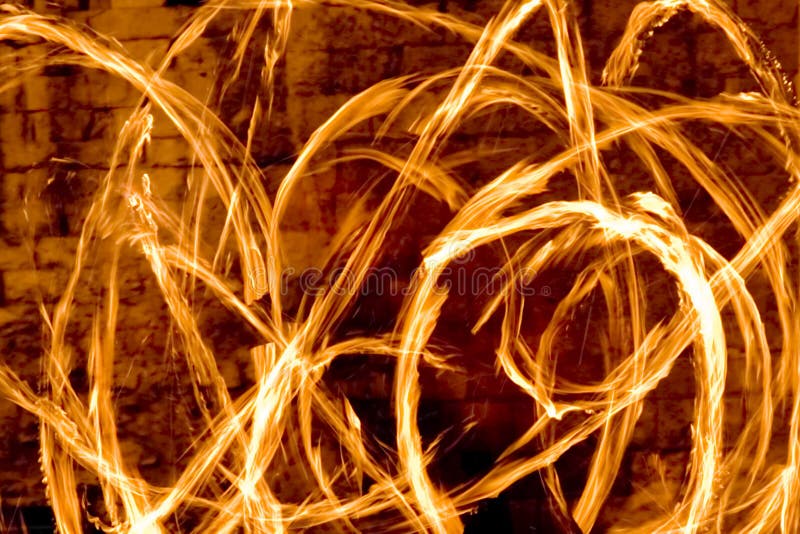 Light trails from the flaming torches of a street performance artist at night. Light trails from the flaming torches of a street performance artist at night