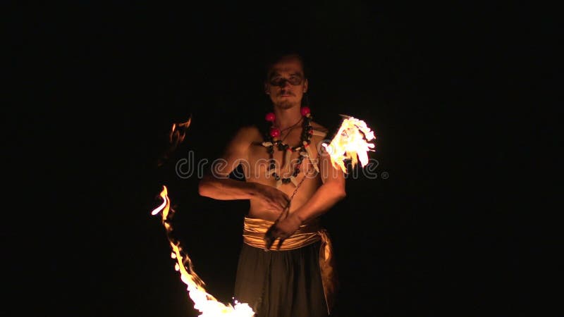 Fire Show Performance. Male Fire Performer Spinning Burning Fire