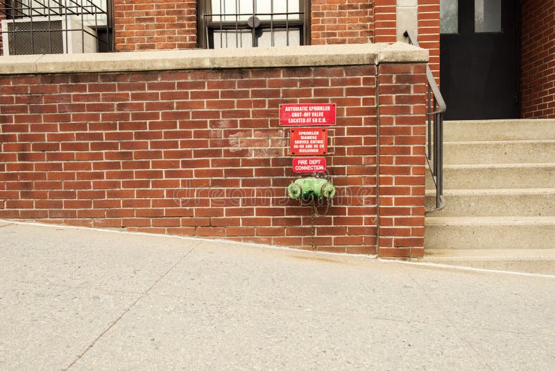 Fire standpipe on a brick wall