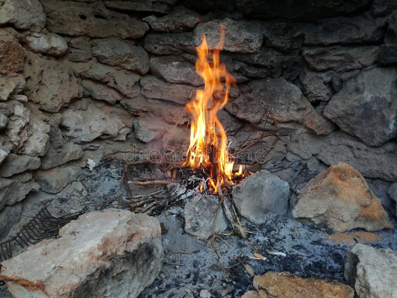 Fire in a stone fireplace stock image. Image of wood 78433163