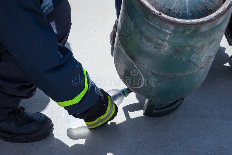 Fire Trainer, Pouring Liquid LPG Gas into Bottle by Upside Down Stock