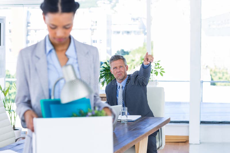 A fired businesswoman holding box stock images