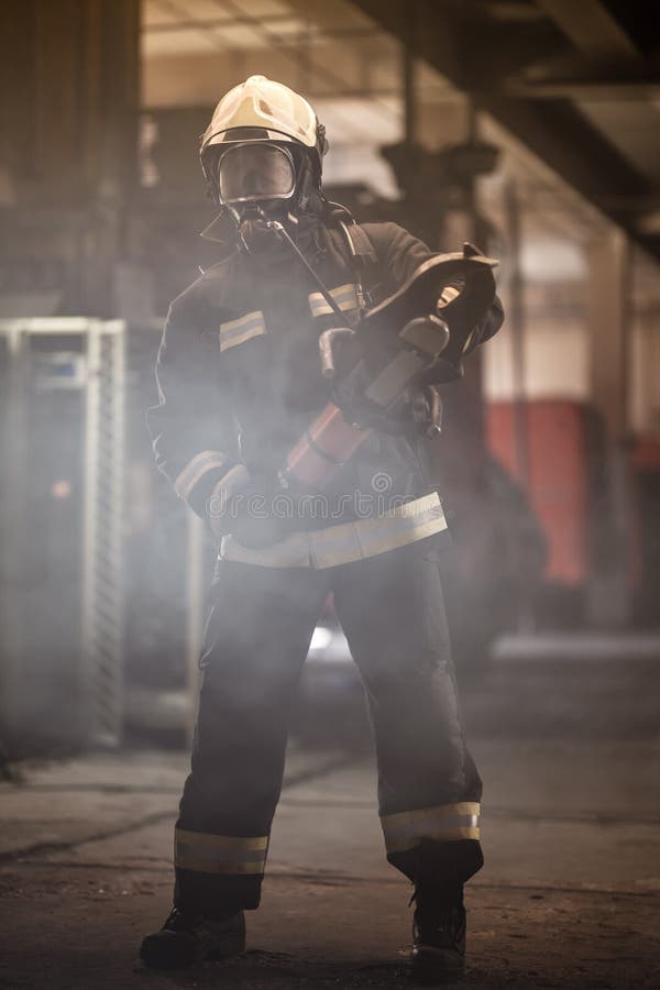 Portrait of a Firefighter Wearing a Helmet and Looking at the Camera ...