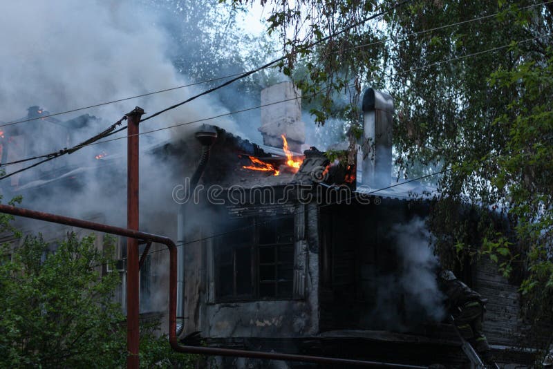 Firefighters extinguish a fire in an old house