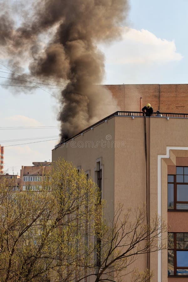 Firefighters extinguish a fire on the roof. City of Balashikha, Moscow region, Russia. Firefighters extinguish a fire on the roof. City of Balashikha, Moscow region, Russia