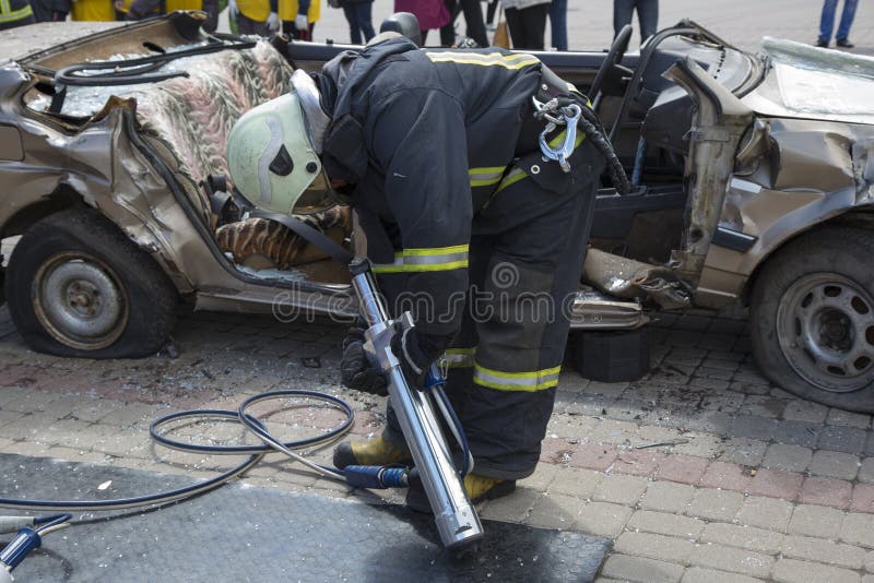 Firefighters with Shears Open the Car Doors after a Serious Car Stock