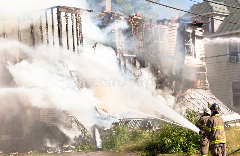 Firefighters Putting out a Fire stock images Firefighters Putting out a Fire stock images