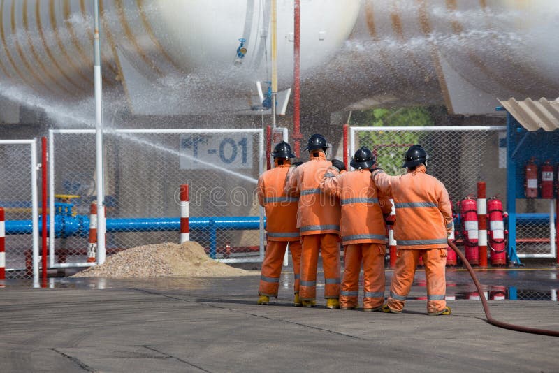 Firefighters Spray Water in LPG Gas Tanks, Fire Extinguishers Ca Stock