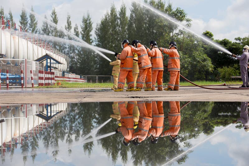 Firefighters Spray Water in LPG Gas Tanks, Fire Extinguishers Ca Stock
