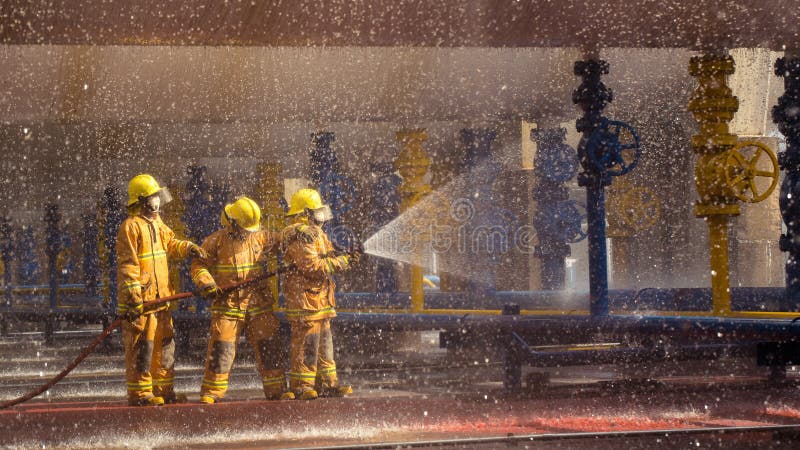 Firefighters training, foreground is drop of water springer royalty free stock photo Firefighters training, foreground is drop of water springer royalty free stock photo