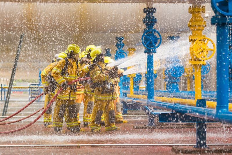 Firefighters training, foreground is drop of water springer stock image Firefighters training, foreground is drop of water springer stock image