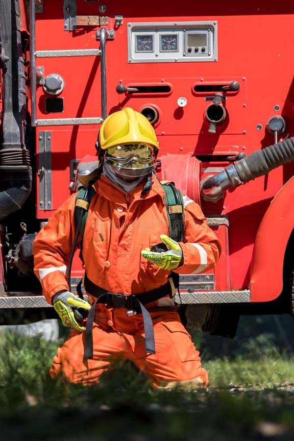 Fireman with Equipment in a Fully Protective Suit Stock Photo Image