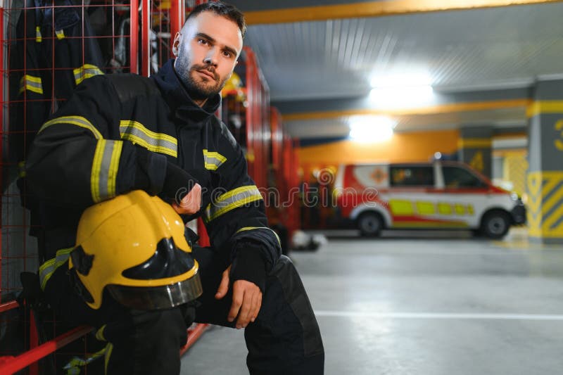 Fireman sitting on bench at fire station royalty free stock photos