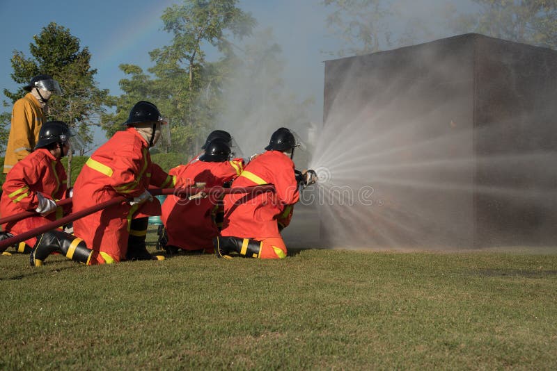 Fireman Watering Against Fire Stock Photo Image of firefighter