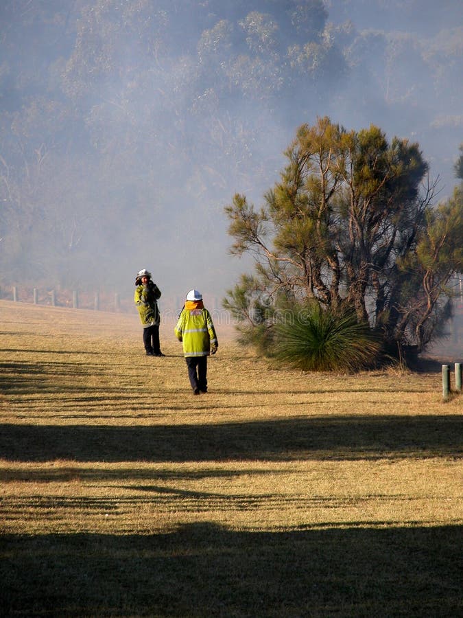 Two bush firefighters shown after defeating a bushfire. Two bush firefighters shown after defeating a bushfire.