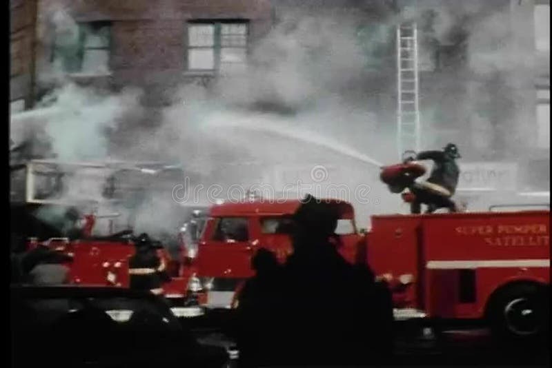 Firemen hosing burning building