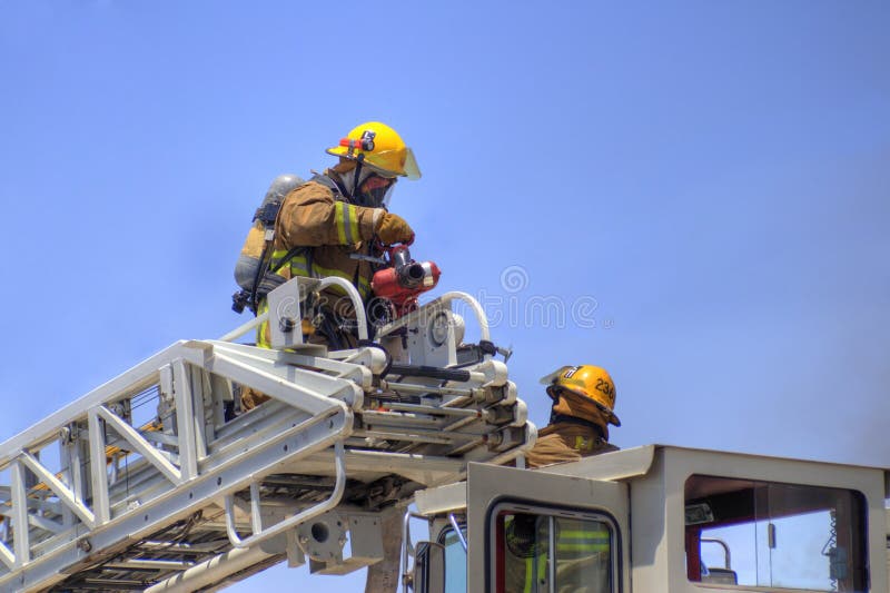Firemen on a ladder truck