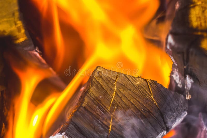 In the fireplace a bright fire burns wood, warms the room and cr stock photo In the fireplace a bright fire burns wood, warms the room and cr stock photo