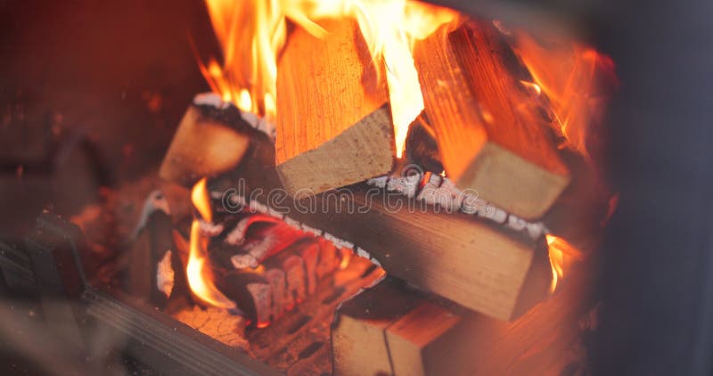 Fireplace burning. Warm cozy burning fire in a brick fireplace close. stock photo