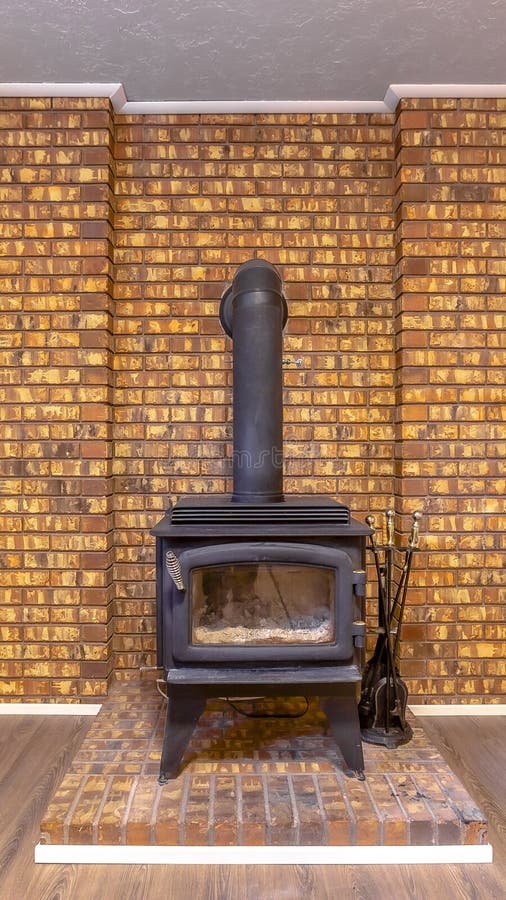 Fireplace Intalled on a Brick Platform and Against the Stone Brick