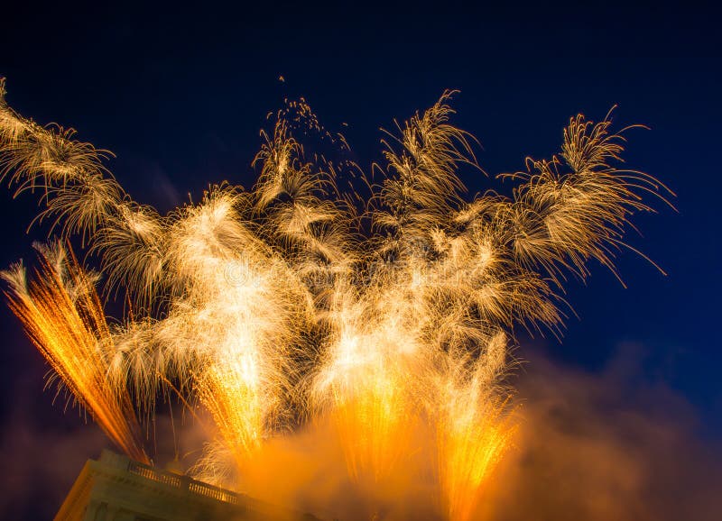 Fireworks in the sky colorful magical festive rays. Fireworks are a class of low explosive pyrotechnic devices used for aesthetic and entertainment purposes. Different types of fireworks in a black background.