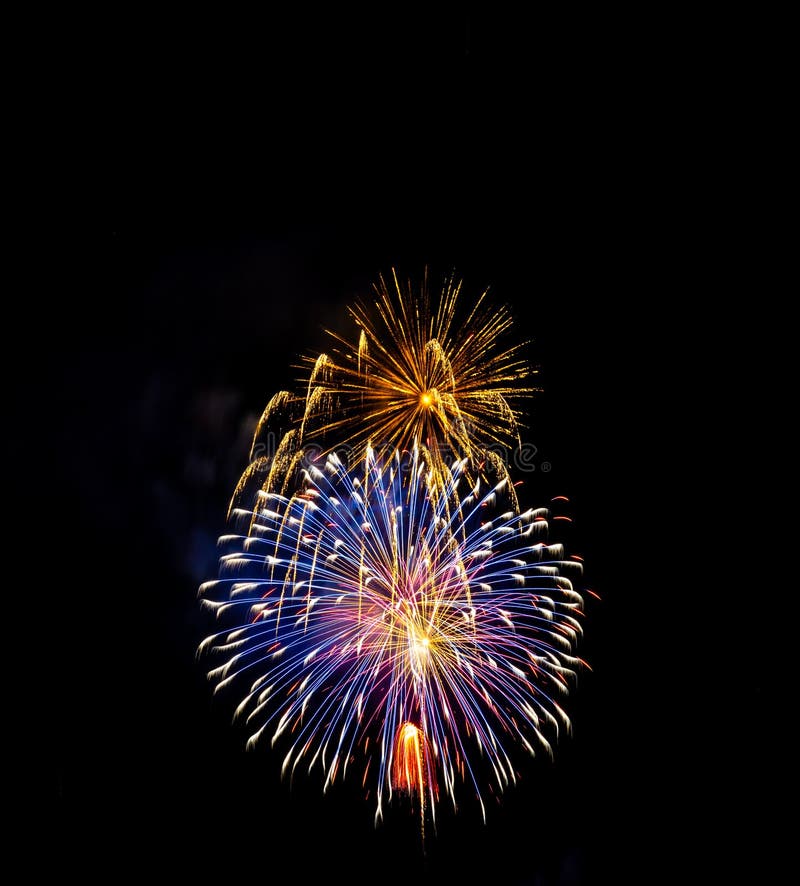 Fireworks Exploding Over the Mountains at night in Colorado royalty free stock image