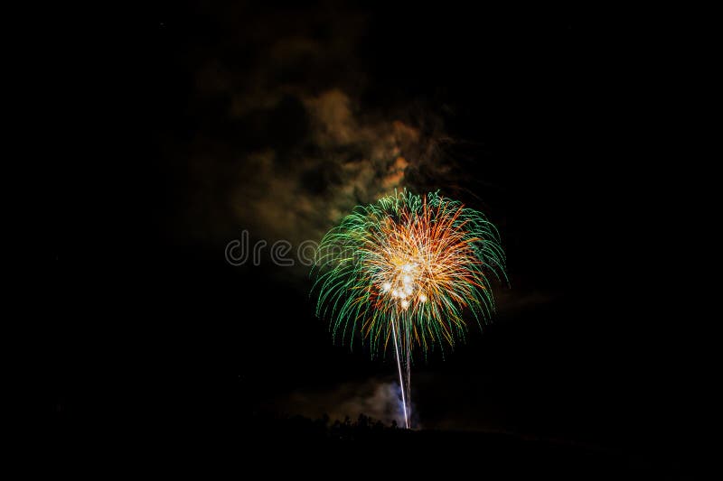 Fireworks Exploding Over the Mountains at night in Colorado royalty free stock photo