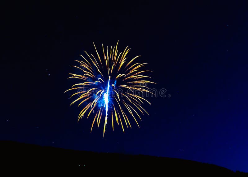 Fireworks Exploding Over the Mountains at night in Colorado stock photos