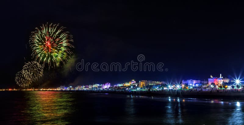 Fireworks explosion night show on seafront. Rimini