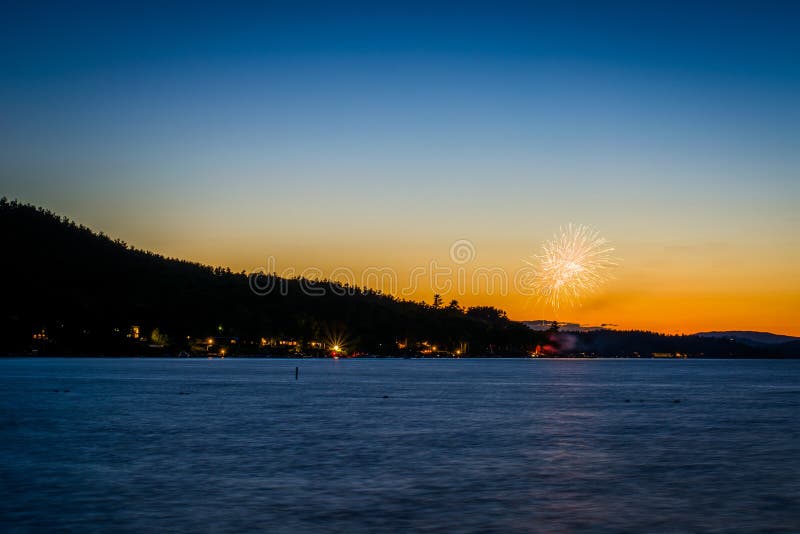 Fireworks and Lake Winnipesaukee at Sunset, at Ellacoya State Pa Stock