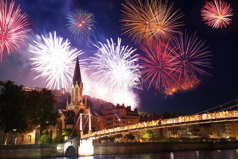 Colorful fireworks light up Lyon sky over the Saone river embankment and St. Georges Church