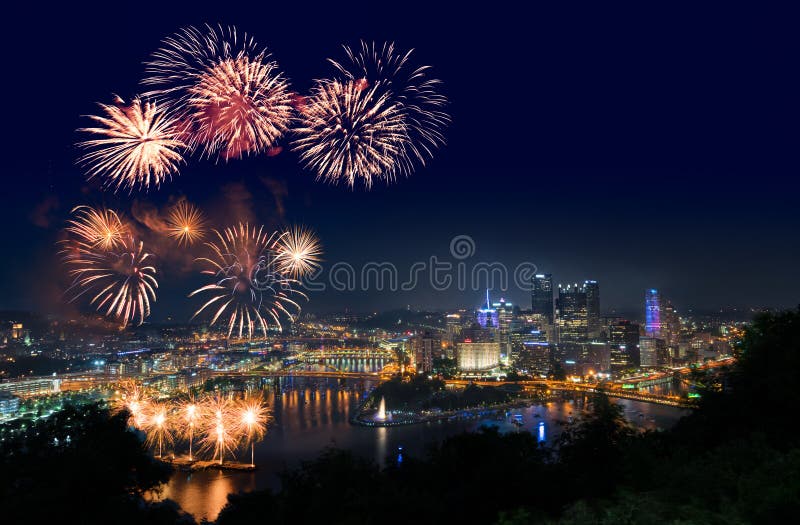 PITTSBURGH, PA - JULY 4, 2018: Fireworks from the river in front of downtown Pittsburgh on Independence Day. PITTSBURGH, PA - JULY 4, 2018: Fireworks from the river in front of downtown Pittsburgh on Independence Day.