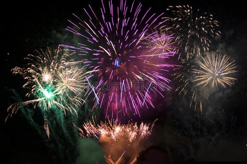 Fireworks exploding over water, at sea or on a river with various colors. Fireworks exploding over water, at sea or on a river with various colors