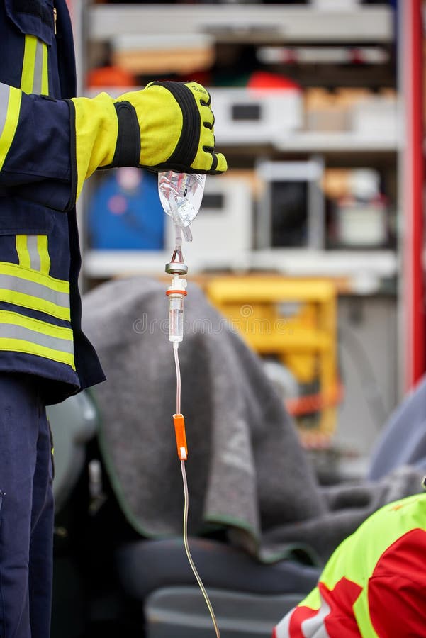 Firefighter in Use with First Aid Kit Serie Firefighter Stock Image
