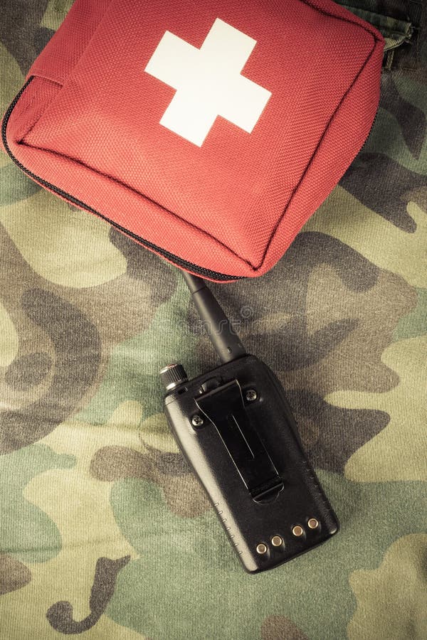 First Aid Kit and Portable Radio on a Fabric with Camouflage Pat Stock