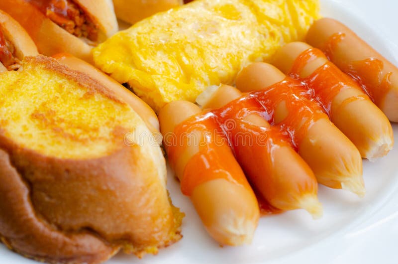 First Breakfast with Sausage, Bread,egg on White Plate in the Morning Time,closeup View. Stock
